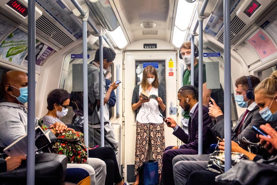 Passengers wearing face masks on the Jubilee Line in London (PA)