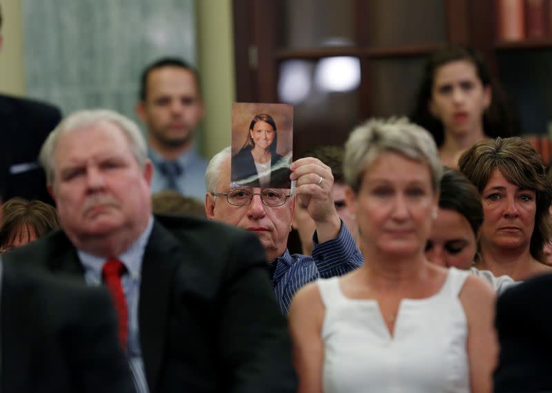 FILE PHOTO: A family member displays a photo of one of the victims of General Motors' ignition/air bag failure at the Senate Commerce, Science and Transportation Subcommittee in Washington