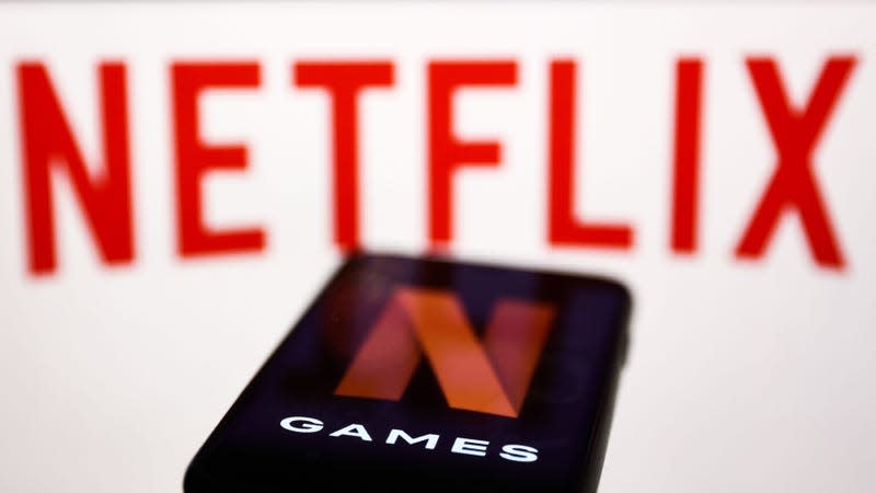 The Netflix logo in front of a cellphone showing "N GAMES".