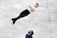 Figure skating USA athletes Ashley Cain-Gribble and Thimothy Leduc, bottom, train at Capital Indoor Stadium at the 2022 Winter Olympics, Wednesday, Feb. 2, 2022, in Beijing. (AP Photo/Bernat Armangue)