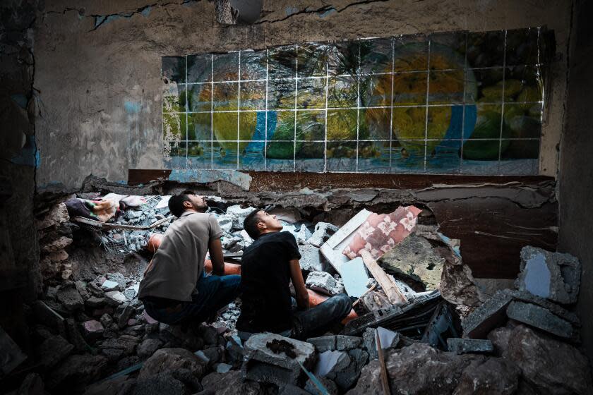 JENIN, OCCUPIED WEST BANK -- OCTOBER 22, 2023: Local residents search the rubble in the aftermath of an Israeli airstrike on the Al Ansar Mosque, where two Palestinians were killed, in the refugee camp in Jenin, Occupied West Bank, Sunday, Oct. 22, 2023. Amid the confrontation between Israel and Hamas, Palestinians rage against another target: Their own rulers, who they see as weak and impotent before Israel's offensive in Gaza and escalating settler violence in the west bank. (MARCUS YAM / LOS ANGELES TIMES)