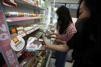 Office workers pick up lunch boxes at a convenience store in Seoul