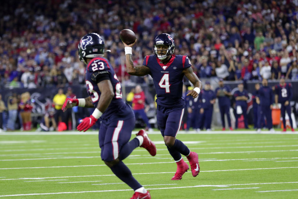 Houston Texans quarterback Deshaun Watson (4) throws a touchdown pass to running back Carlos Hyde (23) during the second half of an NFL wild-card playoff football game against the Buffalo Bills Saturday, Jan. 4, 2020, in Houston. (AP Photo/Michael Wyke)