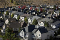 In this Oct. 12, 2018, photo, homes fill a small valley in Reno, Nev. A population inrush to Nevada has been driven by people seeking more affordable housing and a growing tech industry around Reno. (AP Photo/John Locher)