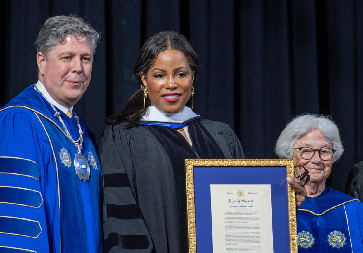 Ilyasah Shabazz receives an honorary degree from Worcester State University President Barry M. Maloney, left, and board of trustees member Maryanne M. Hammond, right, during the WSU commencement May 14, 2022, at the DCU Center.