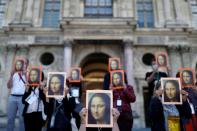 Paris tour guides gather at Le Louvre museum in Paris