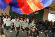 Chinese army advisors ((L) attend a graduation ceremony at Army Institute in Kampong Speu province March 12, 2015. REUTERS/Samrang Pring