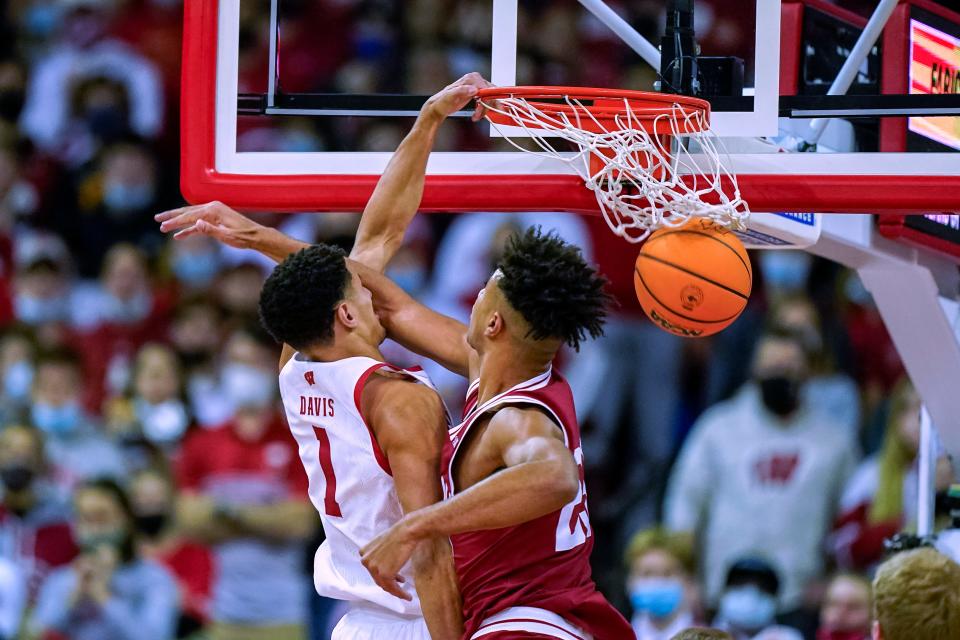 Wisconsin's Johnny Davis (1) dunks against Indiana's Trayce Jackson-Davis (23) during the first half of an NCAA college basketball game Wednesday, Dec. 8, 2021, in Madison, Wis. (AP Photo/Andy Manis)