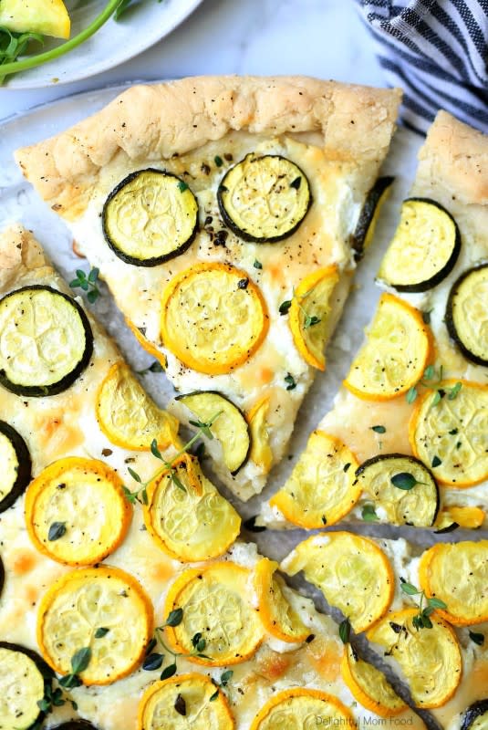 <p>Delightful Mom Food</p><p>This white zucchini pizza is a beautiful composition of delicate goat cheese with summer's finest zucchini squash topped on America’s favorite dish—pizza!</p><p><strong>Get the recipe: <a href="https://delightfulmomfood.com/zucchini-goat-cheese-pizza/" rel="nofollow noopener" target="_blank" data-ylk="slk:Zucchini Goat Cheese Pizza;elm:context_link;itc:0;sec:content-canvas" class="link ">Zucchini Goat Cheese Pizza</a></strong></p>