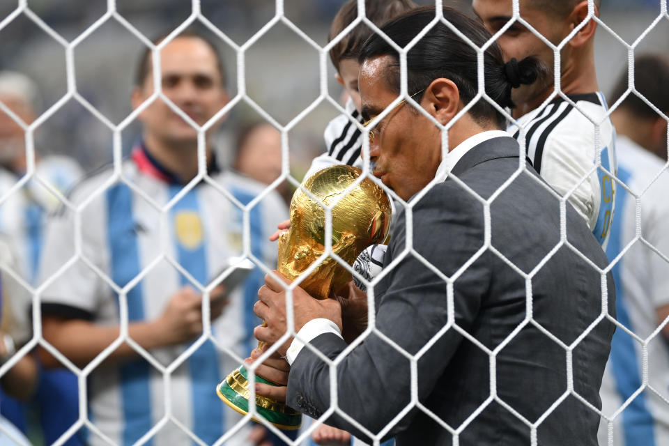 LUSAIL CITY, QATAR - DECEMBER 18: Nusret Goekce, nicknamed Salt Bae, kisses the FIFA World Cup Qatar 2022 Winner's Trophy after the FIFA World Cup Qatar 2022 Final match between Argentina and France at Lusail Stadium on December 18, 2022 in Lusail City, Qatar. (Photo by Dan Mullan/Getty Images)