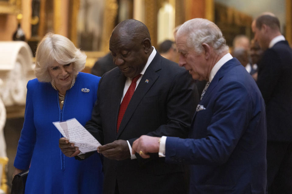 Britain's King Charles III, right, Camilla, the Queen Consort and President Cyril Ramaphosa of South Africa view a display of South African items from the Royal Collection at Buckingham Palace, London, Tuesday Nov. 22, 2022, during the two day state visit to the UK by the South African president. (Dan Kitwood/Pool via AP)