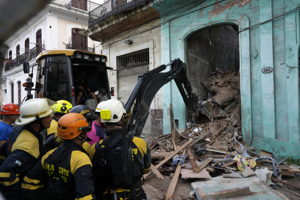 FILE - Firefighters clear debris from a building on Lamparilla street that partially collapsed inwardly, killing three people, in Havana, Cuba, Oct. 4, 2023. The Cuban government has in the past acknowledged the problem of housing deterioration, but says the lack of material resources prevents it from tackling it. (AP Photo/Ramon Espinosa, File)