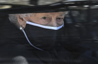 Britain's Queen Elizabeth II follows the coffin in a car as it makes it's way past the Round Tower during the funeral of Britain's Prince Philip inside Windsor Castle in Windsor, England Saturday April 17, 2021. (Leon Neal/Pool via AP)