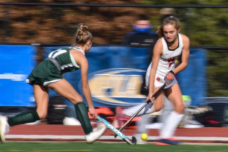 In a motion shot, Gwynedd Mercy's Sydney Mandato dribbles past a Twin Valley defender during the PIAA Class 2A field hockey championship in Whitehall on Saturday, Nov. 20, 2021. Twin Valley won, 3-2.