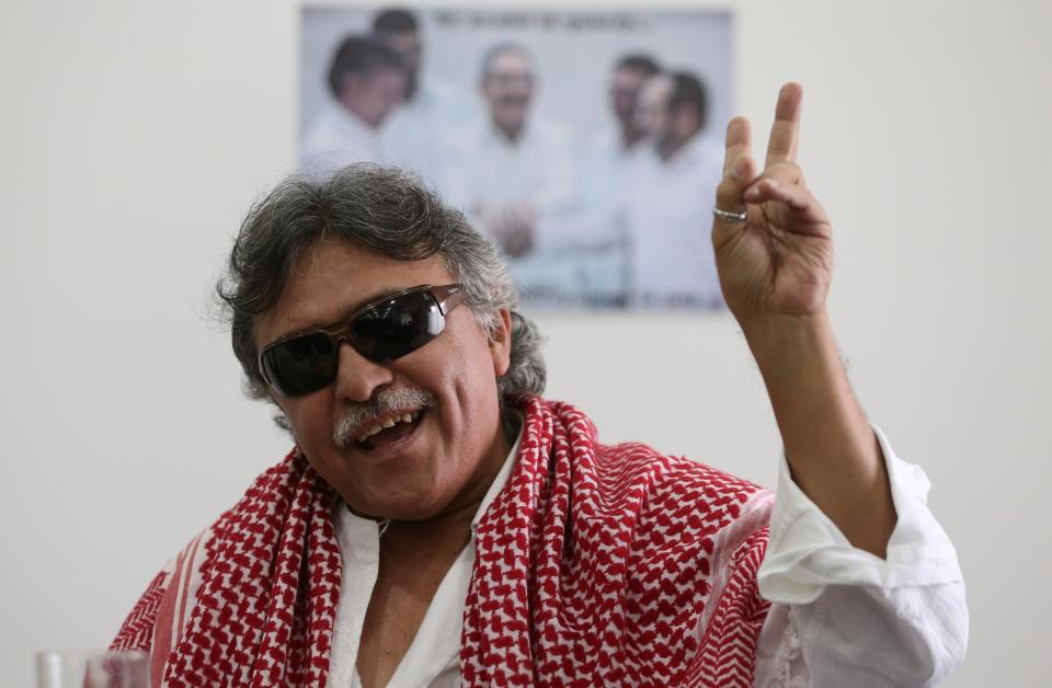 FILE - In this Dec. 6, 2016 file photo, Revolutionary Armed Forces of Colombia, FARC, rebel commander and peace negotiator Seuxis Hernandez, alias Jesus Santrich, flashes a victory hand signal at the end of a press conference in Bogota, Colombia. The Special Peace Tribunal investigating crimes during the country’s long civil conflict announced Wednesday, May 15, 2019, that Hernandez, should not be extradited to the United States on a drug warrant. (AP Photo/Fernando Vergara, File)