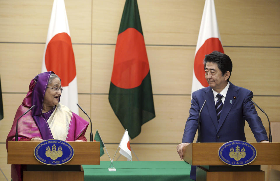 Bangladesh's Prime Minister Sheikh Hasina, left, and Japan's Prime Minister Shinzo Abe, right, look at each other during their joint press conference at Abe's official residence Wednesday, May 29, 2019, in Tokyo. Hasina is wooing Japan for aid, trade and investment in a visit that highlights cordial relations with the administration of Abe. (AP Photo/Eugene Hoshiko, Pool)