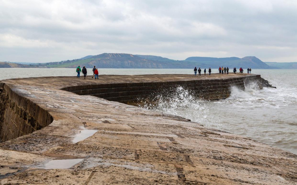 Visitors enjoy some cool spring weather at Lyme Regis in Dorset