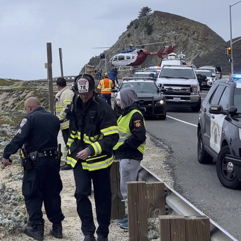 FILE - In this image from video provided by San Mateo County Sheriff's Office, emergency personnel respond after a Tesla plunged off a Northern California cliff along the Pacific Coast Highway, Monday, Jan. 2, 2023, near an area known as Devil's Slide, leaving four people in critical condition. The driver of the car who seriously injuring himself, his wife and their two young children, has been charged with attempted murder. (San Mateo County Sheriff's Office via AP, File)