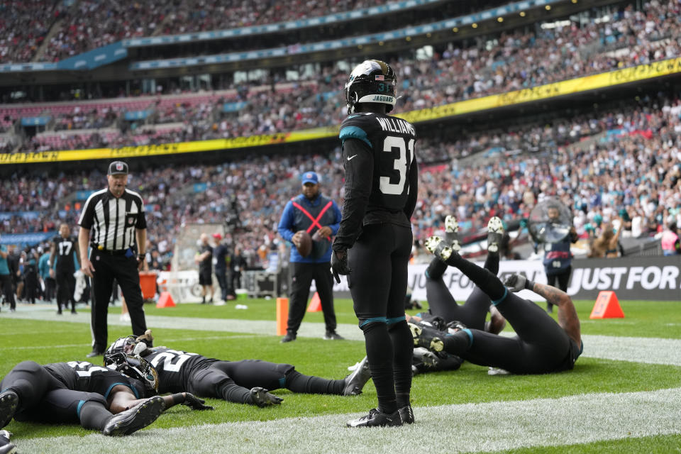 Jacksonville Jaguars cornerback Darious Williams (31) celebrates with teammates after scoring a touchdown during an NFL football game between the Atlanta Falcons and the Jacksonville Jaguars at Wembley stadium in London, Sunday, Oct. 1, 2023. (AP Photo/Kirsty Wigglesworth)