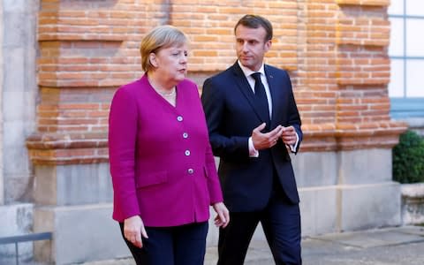 FILE PHOTO: French President Emmanuel Macron and German Chancellor Angela Merkel welcome European Commission president-elect Ursula Von der Leyen (not pictured) after a joint Franco-German cabinet meeting in Toulouse, France, October 16, 2019. REUTERS/Regis Duvignau/File Photo - Credit: Regis Duvignau/REUTERS