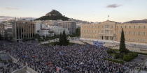 Protesters attend a rally in front of the parliament building, calling on the government to clinch a deal with its international creditors and secure Greece's future in the Eurozone, in Athens, Greece June 22, 2015. REUTERS/Marko Djurica