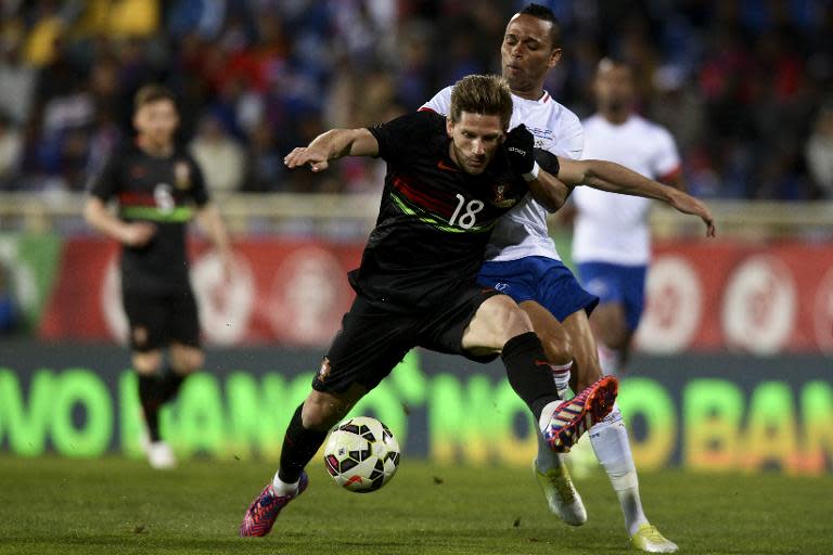 Portugal's midfielder Adrien Silva (L) vies with Cape Verde's midfielder Nuno Rocha during the EURO 2016 friendly football match in Estoril outside Lisbon on March 31, 2015