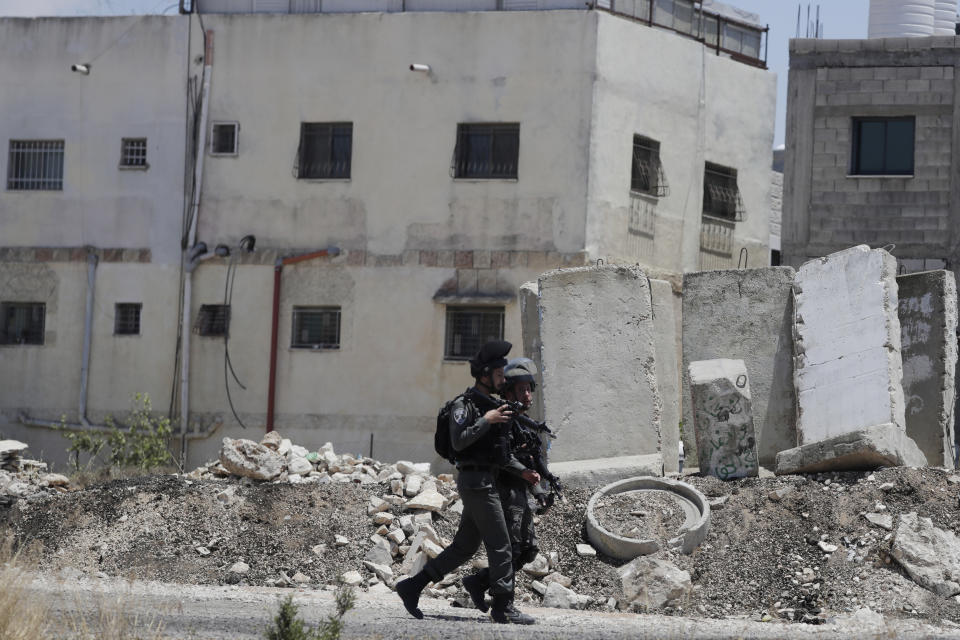 Israeli police work at the site of a vehicle attack near Hizmeh Junction in the West Bank, Wednesday, June 16, 2021. The Israeli military on Wednesday shot and killed a Palestinian woman who it said tried to ram her car into a group of soldiers guarding a West Bank construction site. (AP Photo/Maya Alleruzzo)