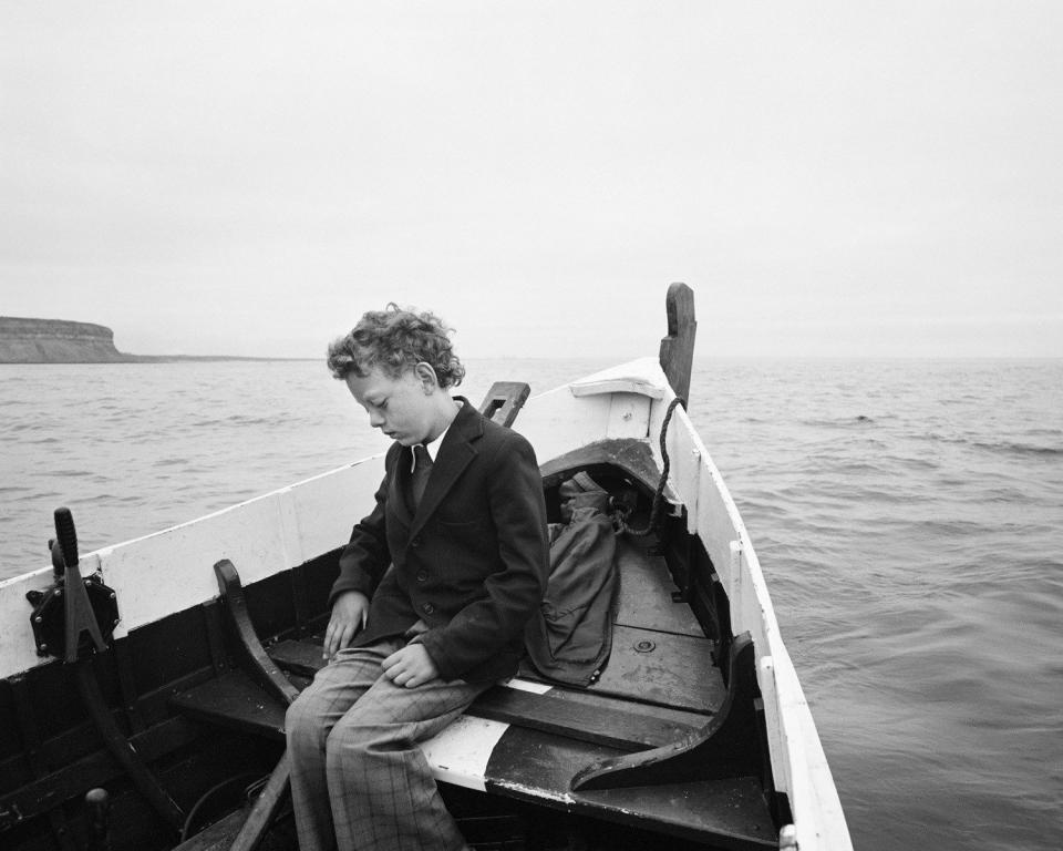 Simon being taken to sea for the first time since his father drowned, Skinningrove, North Yorkshire, 1983 - Chris Killip