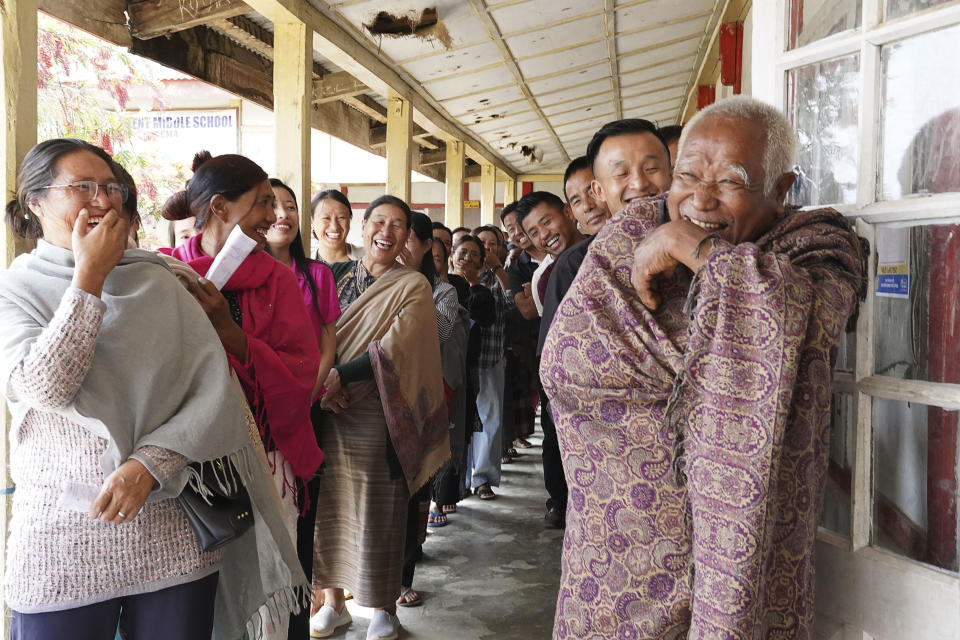 FILE- Angami Nagas laugh as an elderly man reacts to the camera at a polling station in Chedema village, in the northeastern Indian state of Nagaland, Friday, April 19, 2024. (AP Photo/Yirmiyan Arthur)