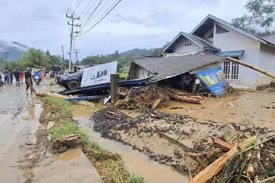 In this image made from video, damaged houses are seen in a village affected by flash flood in Langgai, West Sumatra, Indonesia, Sunday, March 10, 2024. Torrential rains have triggered flash floods and a landslide on Indonesia's Sumatra island leaving a number of people dead and missing, officials said Sunday. (AP Photo)