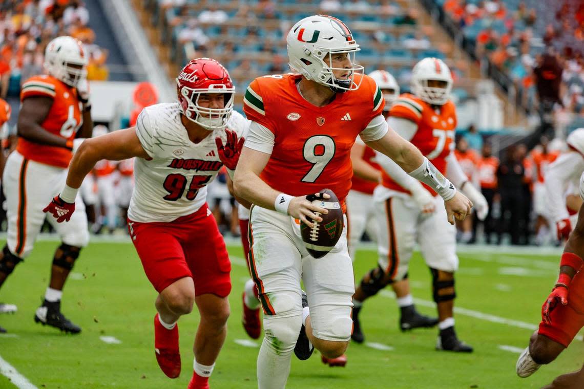 Miami Hurricanes quarterback Tyler Van Dyke (9) scrambles in the backfield during the first quarter in the game against the Louisville Cardinals on Saturday, November 18, 2023.