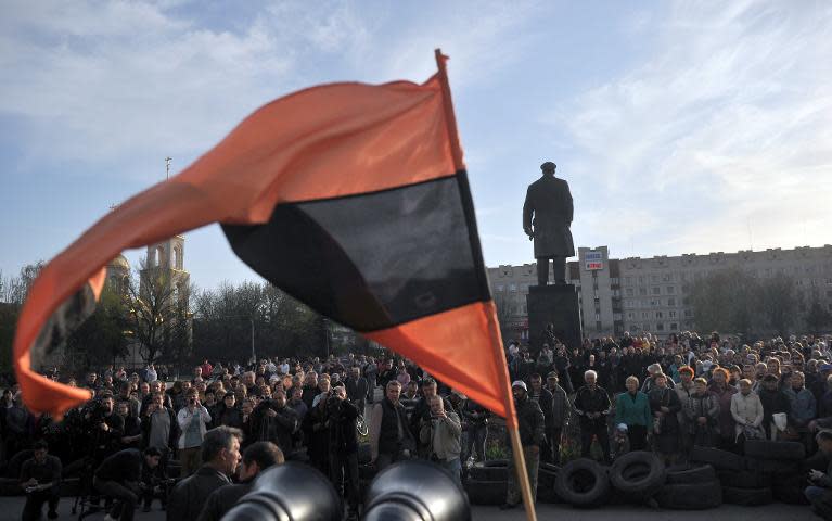 Pro-Russian activists take part in a rally in front of the regional state building seized by pro-Russian separatists, in the eastern Ukrainian city of Slavyansk, on April 18, 2014