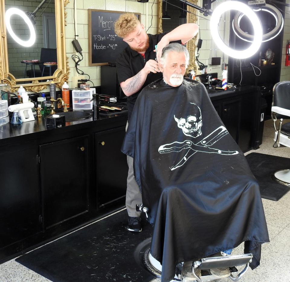 Kobe Rust gives a haircut to Larry Holdsworth at the new Locals Barbershop Downtown at 115 S. Sixth St. The second location for Locals Barbershop takes walk-ins mostly and offers old-fashioned barbering, including straight razor shaves.