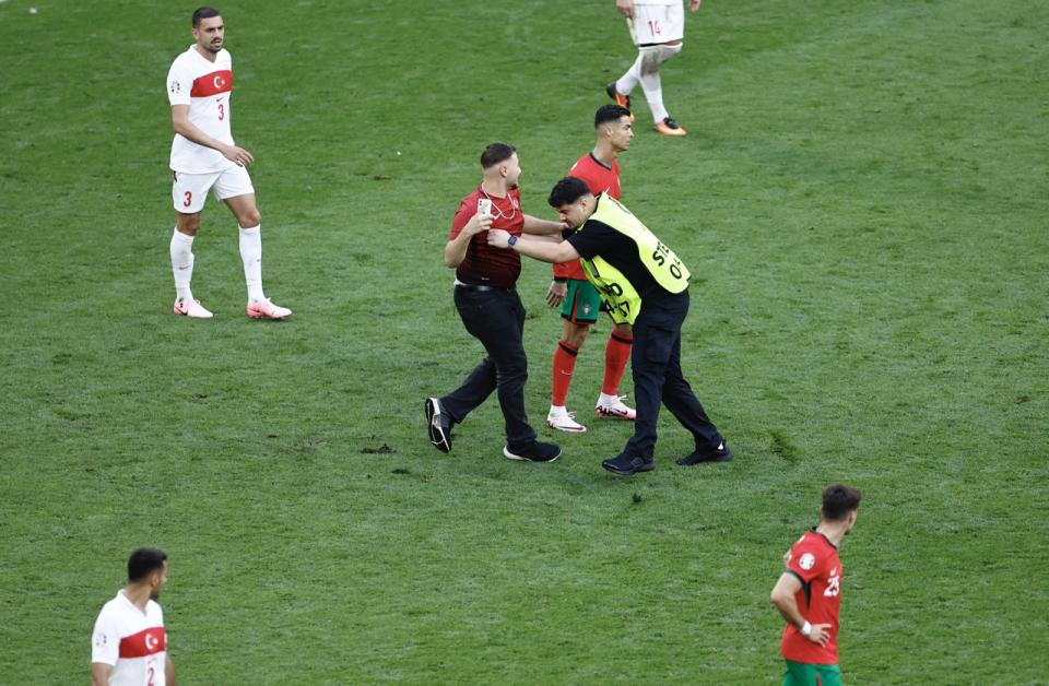 <strong><u>‘It is a concern, today we were lucky”: Martinez calls for fans to stay in stands as pitch invaders swarm Ronaldo</u></strong>