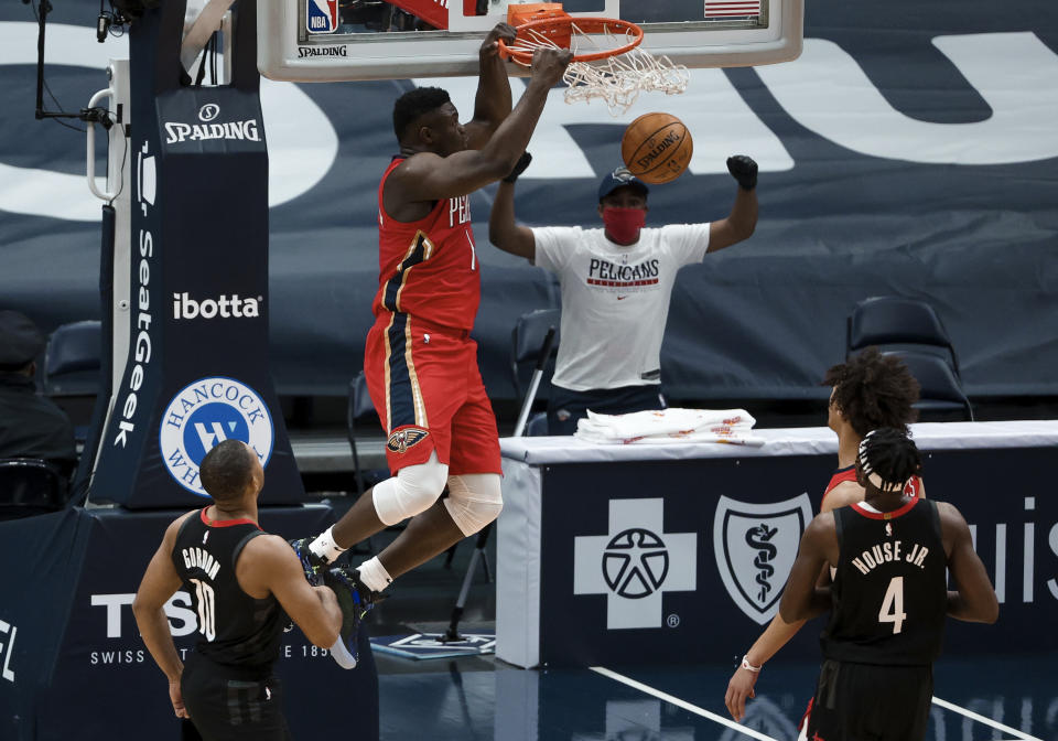 New Orleans Pelicans forward Zion Williamson (1) dunks past Houston Rockets guard Eric Gordon (10) during the first quarter of an NBA basketball game in New Orleans, Saturday, Jan. 30, 2021. (AP Photo/Derick Hingle)