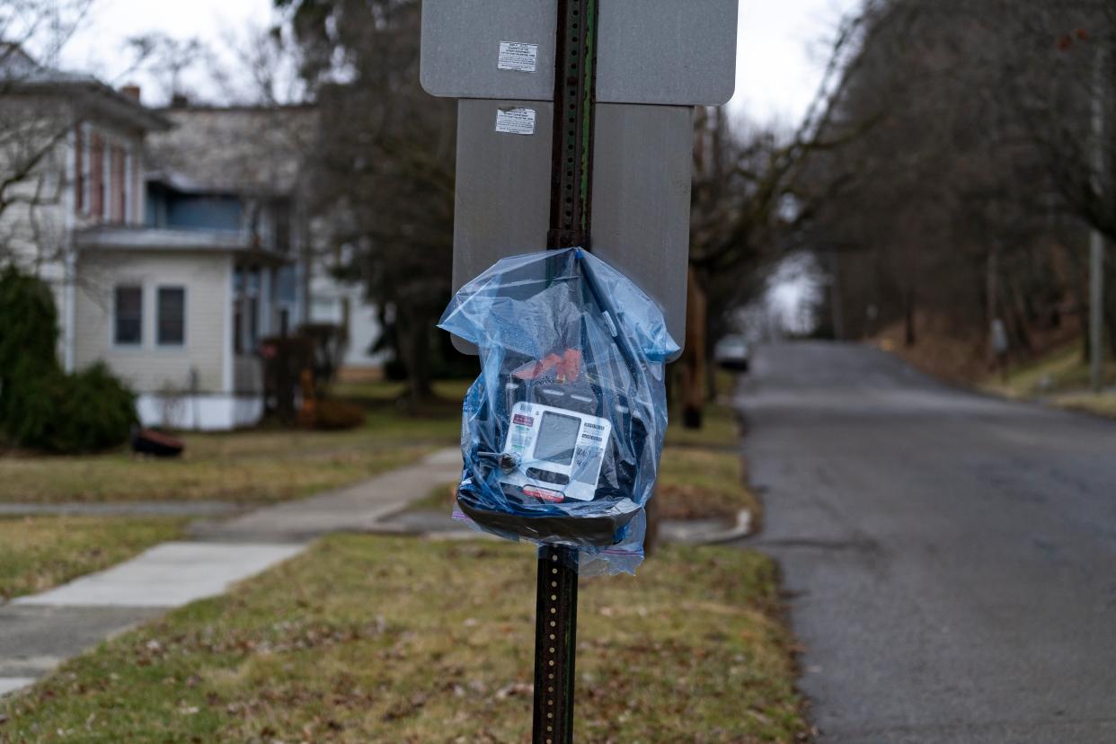 An air quality monitor hangs on a stop sign (Michael Swensen/Getty Images)