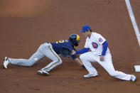 Chicago Cubs first baseman Anthony Rizzo, right, waits on the throw to first base as Milwaukee Brewers' Christian Yelich, left, dives back to the base during the first inning of a baseball game in Chicago, Thursday, Aug. 13, 2020. (AP Photo/Jeff Haynes)