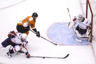 Washington Capitals defenseman Radko Gudas (33) stops a puck in front of Philadelphia Flyers right wing Jakub Voracek (93) at Washington Capitals goaltender Braden Holtby (70) in the net during the second period of an NHL hockey playoff game Thursday, Aug. 6, 2020, in Toronto. (Cole Burston/The Canadian Press via AP)