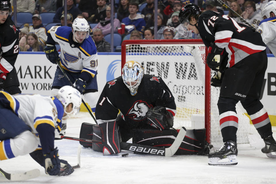 Buffalo Sabres goaltender Ukko-Pekka Luukkonen (1) blocks a shot by St. Louis Blues center Nikita Alexandrov (59) during the first period of an NHL hockey game Wednesday, Nov. 23, 2022, in Buffalo, N.Y. (AP Photo/Joshua Bessex)