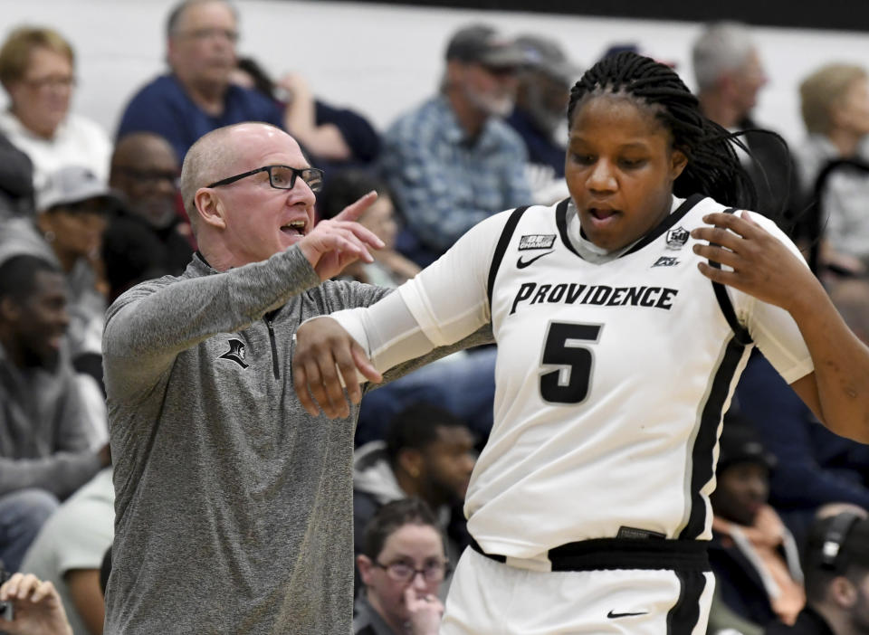 Providence head coach Jim Crowley yells from the sideline past Janai Crooms (5) during the second half of an NCAA college basketball game, Wednesday, Feb. 1, 2023, in Providence, R.I. (AP Photo/Mark Stockwell)