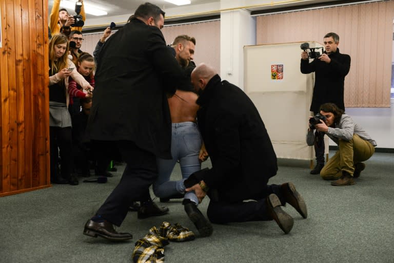 Security staff of Czech President Milos Zeman (not in picture) detained a woman being member of the Femen organisation after she attacked the President on January 12, 2018 at the polling station in Prague