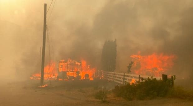 Video captured by a Lytton resident fleeing the B.C. community on June 30, 2021 shows numerous structures on fire. (2 Rivers Remix Society/Vimeo - image credit)