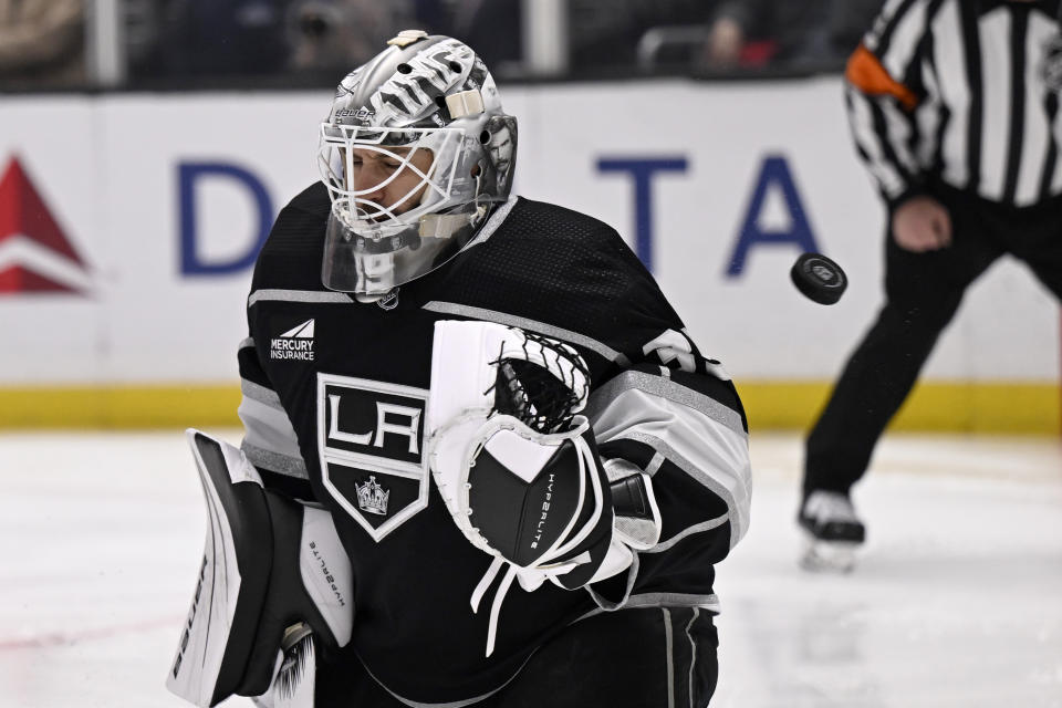 The puck gets past Los Angeles Kings goaltender Cam Talbot for a Calgary Flames goal during the first period of an NHL hockey game in Los Angeles, Saturday, Dec. 23, 2023. (AP Photo/Alex Gallardo)