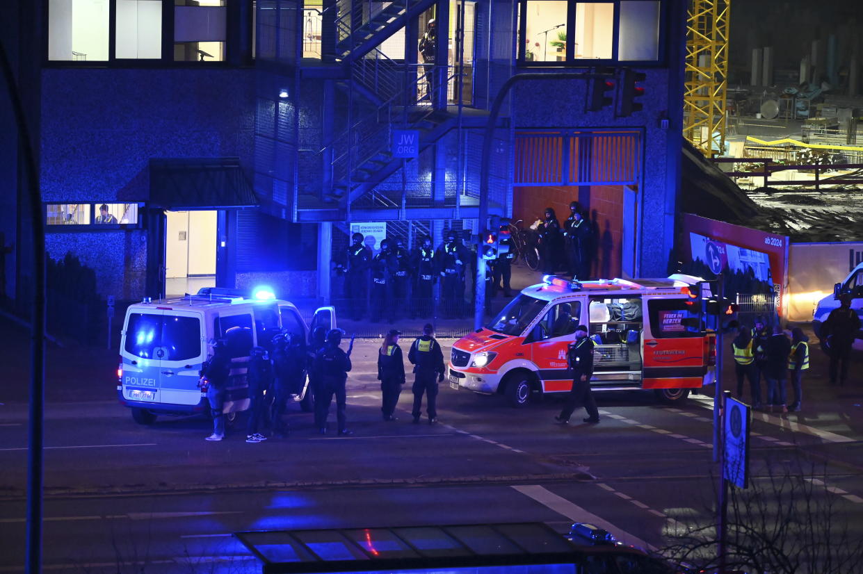 Armed police officers near the scene of a shooting in Hamburg, Germany on Thursday March 9, 2023 after one or more people opened fire in a church. The Hamburg city government says the shooting took place in the Gross Borstel district on Thursday evening. (Jonas Walzberg/dpa via AP)