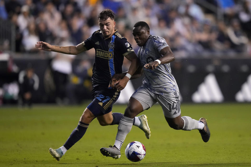 Philadelphia Union's Kai Wagner, left, and CF Montréal's Sunusi Ibrahim battle for the ball during the first half of an MLS soccer match, Saturday, June 3, 2023, in Chester, Pa. (AP Photo/Matt Slocum)