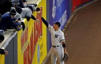 Oct 16, 2017; Bronx, NY, USA; New York Yankees right fielder Aaron Judge (99) gives a ball to a fan during the ninth inning against the Houston Astros during game three of the 2017 ALCS playoff baseball series at Yankee Stadium. Mandatory Credit: Adam Hunger-USA TODAY Sports