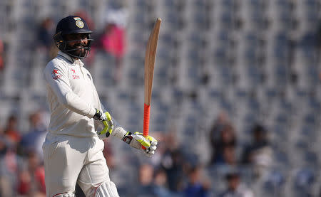 Cricket - India v England - Third Test cricket match - Punjab Cricket Association Stadium, Mohali, India - 28/11/16. India's Ravindra Jadeja celebrates his half century. REUTERS/Adnan Abidi