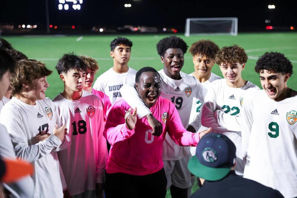 Frederick Douglass goalkeeper Delfin Iteriteka (0) celebrated with his team after the Broncos defeated Paul Laurence Dunbar in a penalty kick shootout during boys high school soccer’s 11th Region Tournament semifinals at Great Crossing High School on Thursday.