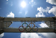 Giant Olympic rings are installed under the walkways of Tower Bridge on June 18, 2012 in London, England. The rings measuring 25 metres by 11 metres will be lowered into view later this month ahead of the London 2012 Olympic games. (Photo by Peter Macdiarmid/Getty Images)