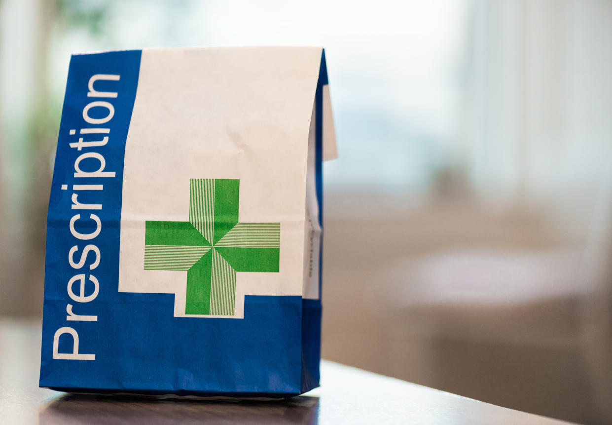 A close-up image of a paper bag containing prescribed medical items.